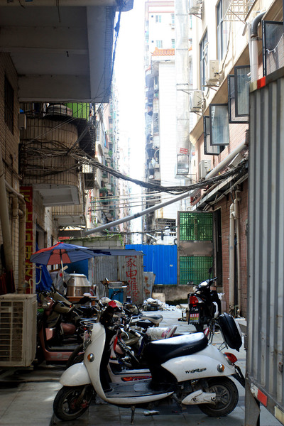 Проходы между домами в Шэньчжэне напоминают джунгли, в которых вместо лиан провода, в вместо кустарников - мусор и мотобайки.